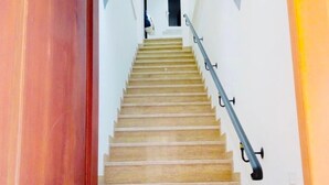 A wooden staircase with a metal handrail leading to a room. - Apartment in the very center of Palermo, within walking distance of the famous 4 canti. (Palermo)