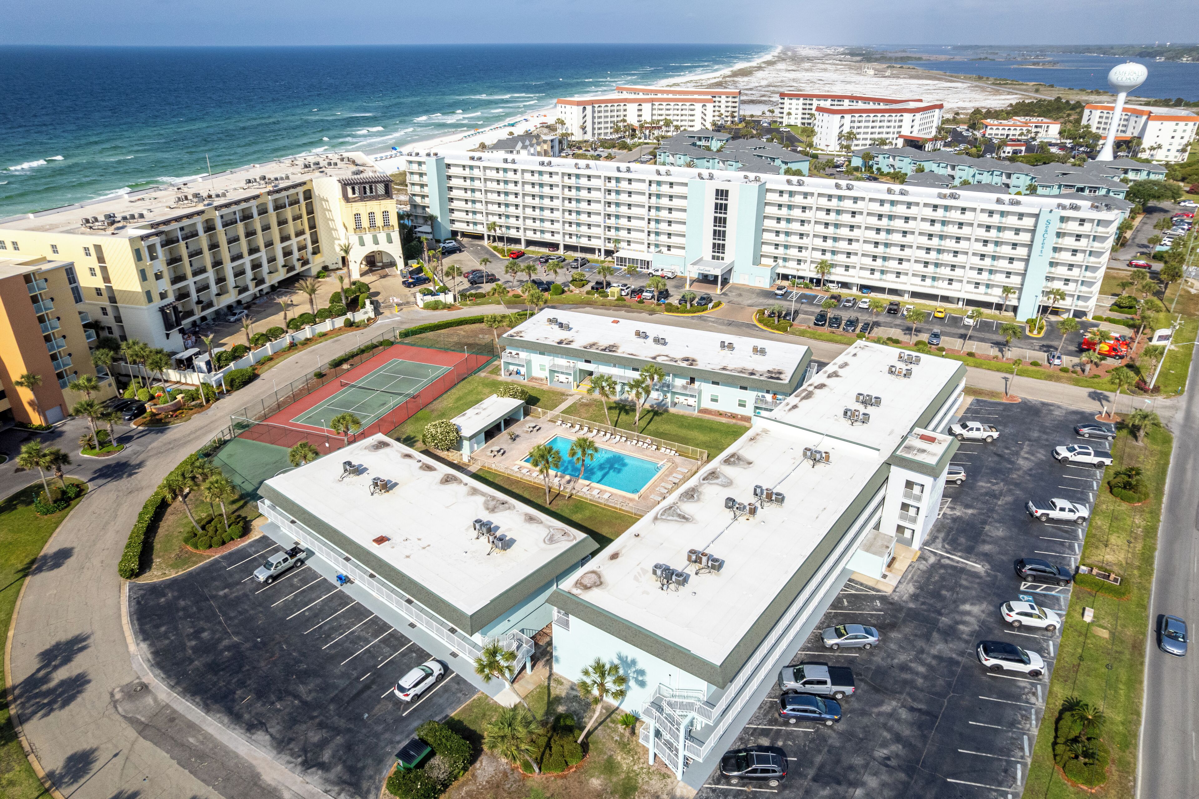 Un hôtel à étages, doté d’une piscine sur le toit et offrant une vue sur la plage.