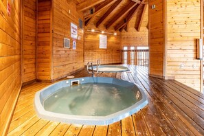 A wooden cabin with two hot tubs and a wooden deck. - Tyra Aspen Condo: Ski In/Out, Close to Town (Breckenridge)