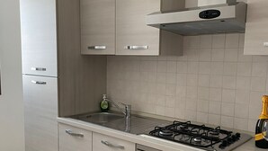 A modern kitchen with a gas stove, stainless steel appliances, and light wood cabinetry. - Like At Home Venice Mestre, bright, family and private parking place. (Venezia)
