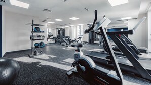 A modern gym with treadmills, weight machines, and exercise balls. - Ibis Tbilisi City (Tbilisi)