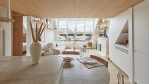 A modern kitchen with a dining area, large windows, and a view of the cityscape. - Masterpiece loft Eiffel Tower view in enchanting Paris (Paris)