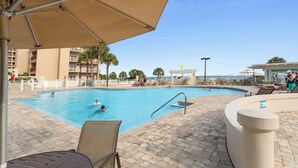 A pool area with multiple swimming pools, lounge chairs, and umbrellas. - 1411 The Tides at Tops'l - Gulf Front, Community Pool, & Kiddie Pool (Miramar Beach)