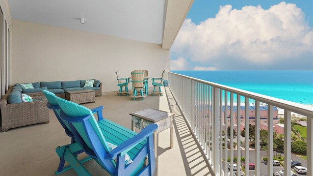 A balcony with a view of the ocean, a sofa, and two chairs. - 1411 The Tides at Tops'l - Gulf Front, Community Pool, & Kiddie Pool (Miramar Beach)