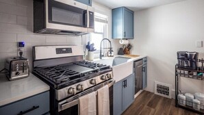 A kitchen with a stove, microwave, toaster, sink, and cabinets. - Walkable to Everywhere in Little Italy- Near CWRU, Cleveland Clinic Main Campus  (Cleveland)