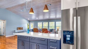 A modern kitchen with a stainless steel refrigerator, a water dispenser, and a marble countertop. - Came & Stayed, Community Pool, Tranquility, Beach Gear Credit Included! (St George Island)