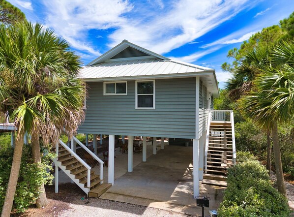 A two-story house with a covered porch and a staircase leading to the upper level. - Came & Stayed, Community Pool, Tranquility, Beach Gear Credit Included! (St George Island)