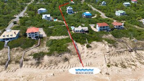 An aerial view of a coastal residential area with houses, a marked path leading to the beach, and a clear indication of beach access. - Came & Stayed, Community Pool, Tranquility, Beach Gear Credit Included! (St George Island)