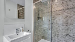 A modern bathroom with a glass-enclosed shower, a white sink, and a mirror above it. - Downs View a Tranquil Space for Two - Pass the Keys (Chartham)