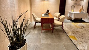 A modern hotel lobby with a reception desk, seating area, and a wall-mounted sign for 'AREIA HOTEL & SPA'. - Areia Boutique Hotel - Puerto Morelos (Puerto Morelos)