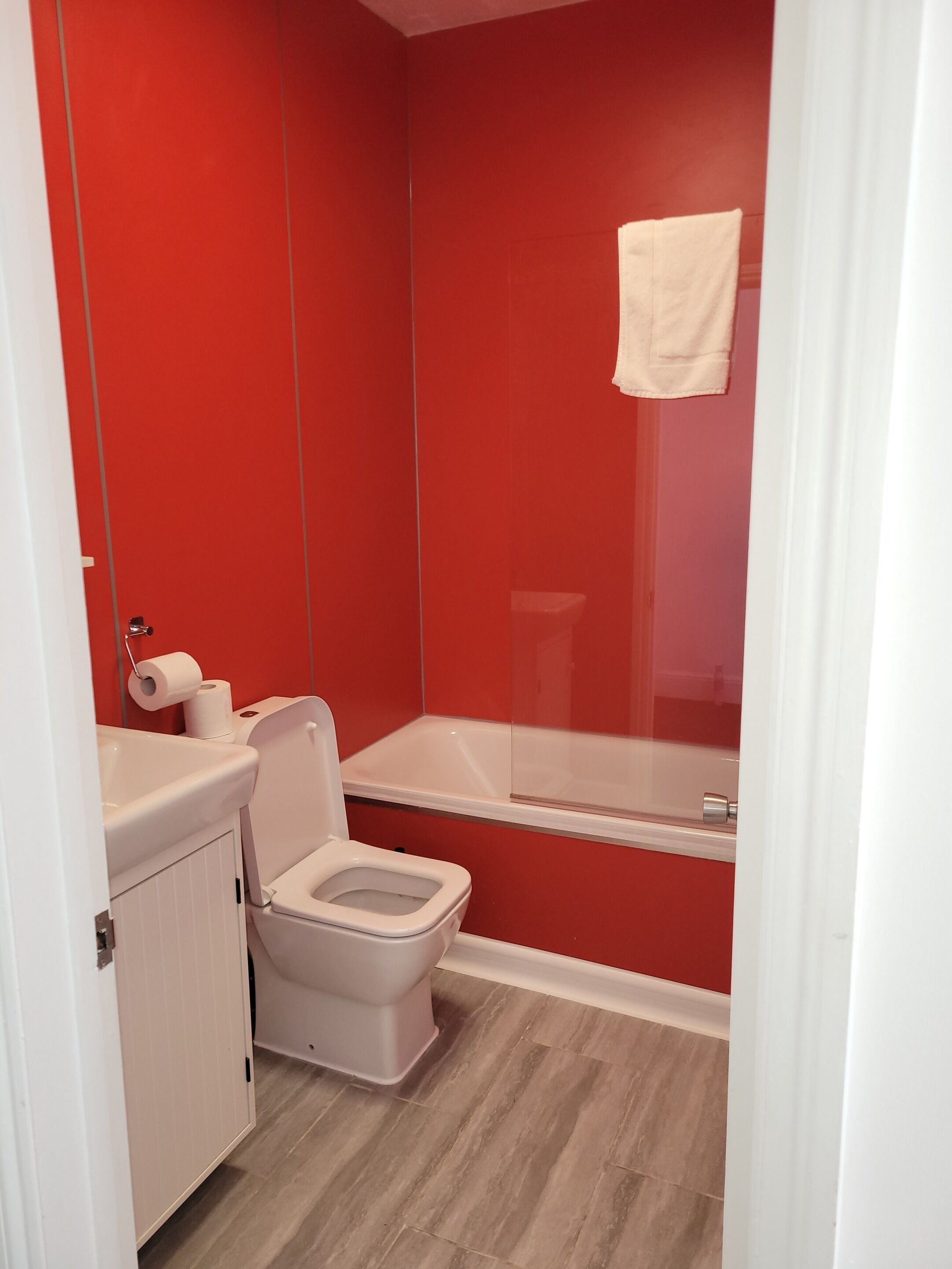 A small bathroom with a toilet, a sink, and a bathtub.