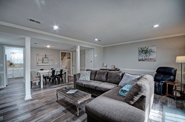 Relax in this stylish living area with a large sofa, coffee table, and comfortable chair.