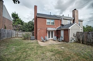 Relax in the covered patio area with Adirondack chairs and a small table.