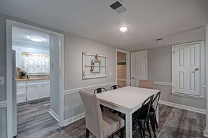 Enjoy meals in this cozy dining area with a table and chairs.