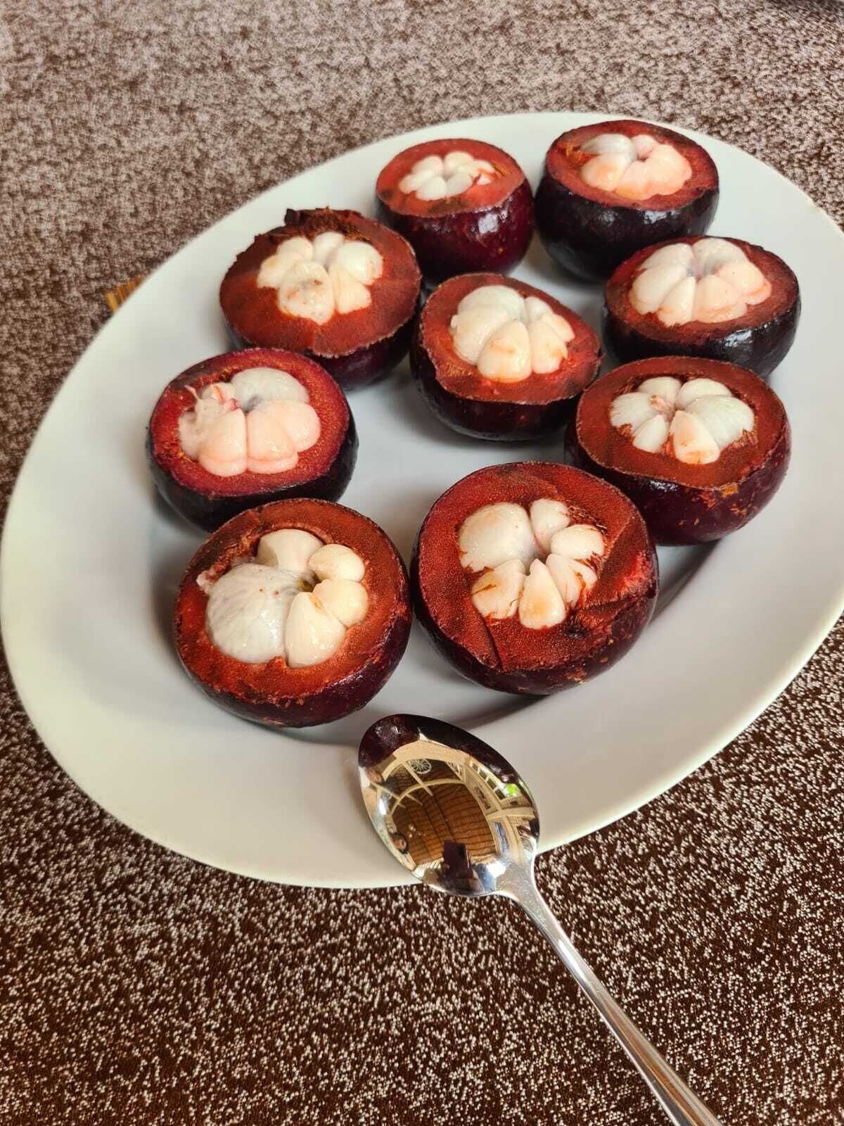 A plate of candied yams with a spoon.