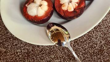 A plate of candied yams with a spoon.