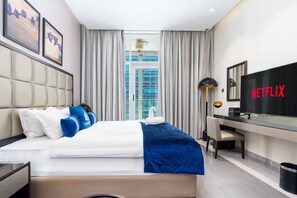 Design Studio, 1 King Bed, Balcony, City View | Living area | 43-inch flat-screen TV with satellite channels, Netflix