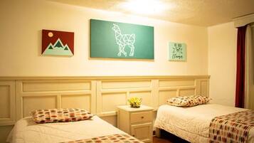 A hotel room with two beds, a nightstand, and wall art.