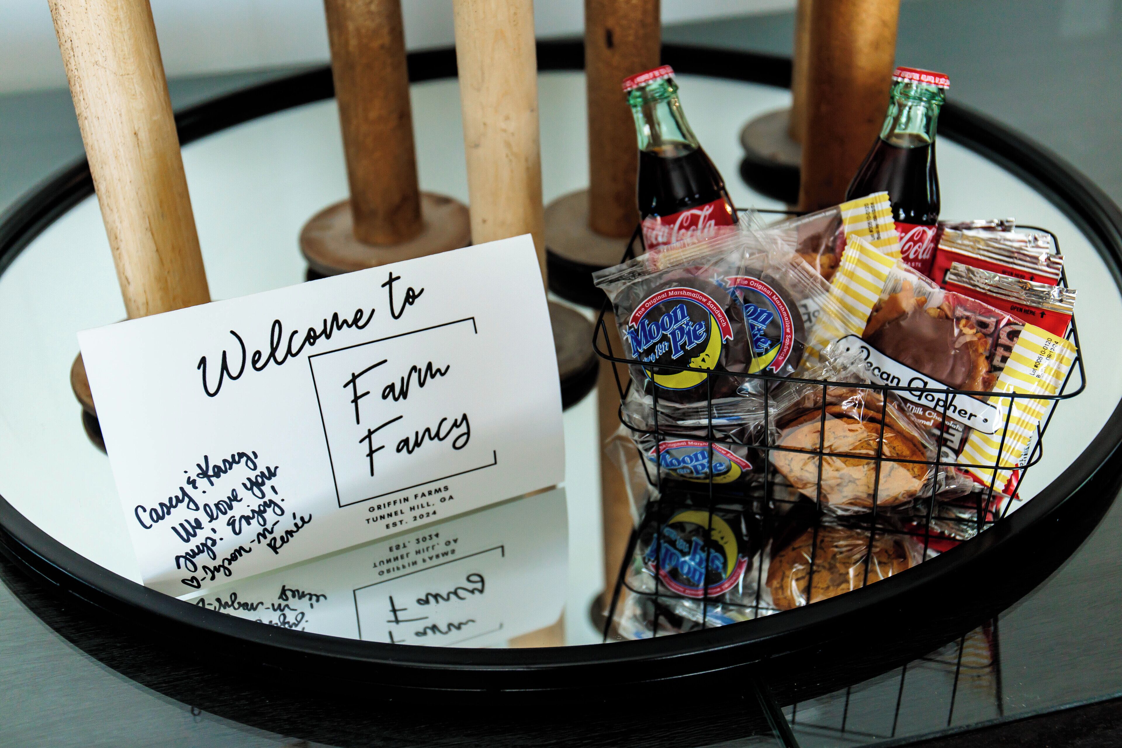 A welcome sign and a basket of snacks on a table.
