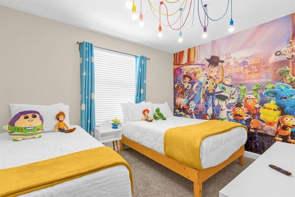 A hotel room with two beds, a large wall mural, and a ceiling light fixture.