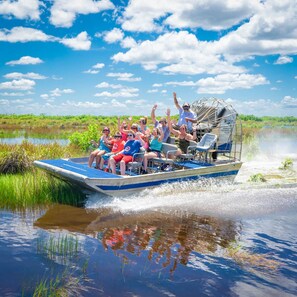 A boat tour with passengers enjoying the scenery. - Hampton Inn & Suites Naples South (Naples)