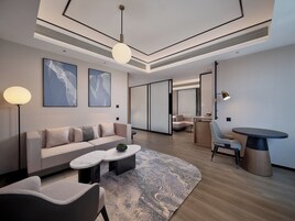 Premium Suite, 1 King Bed | Living area | 55-cm flat-screen TV with cable channels