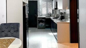A modern kitchen with a central island, built-in appliances, and a sleek design.