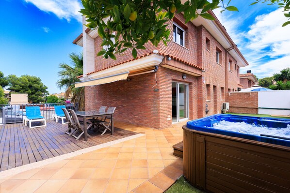 Relax on the patio with a hot tub, dining area, and pool table.