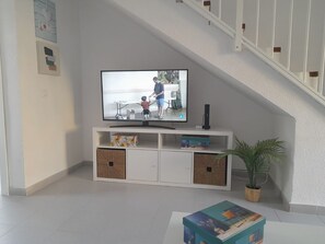 Relax in this stylish living room with a flat-screen TV, storage compartments, and a cozy reading nook.