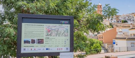 A signboard with information about prehistoric routes in Casabereja, including a map and details on the route's difficulty level.