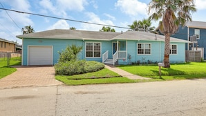 A single-story house with a garage, a front porch, and a palm tree. - 1 Mi to Moody Gardens & Beaches: Galveston Home (Galveston)