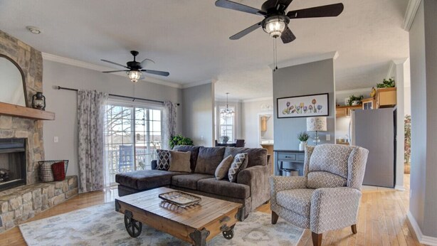 A spacious living room with a sectional sofa, a patterned armchair, a wooden coffee table, and a fireplace. - Private Farmhouse Retreat in Shoal Creek (Exeter)