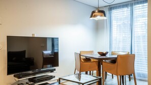 Relax in this stylish living space with a flat-screen TV, media player, and comfortable dining area.