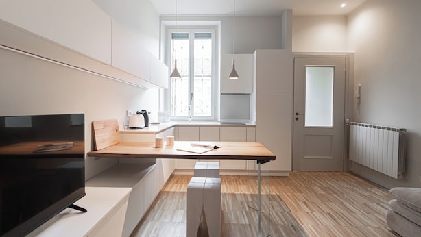 A modern kitchen with a wooden countertop, a built-in oven, and a window with natural light. - Italianway Easy - Gentilino 15 (Milano)