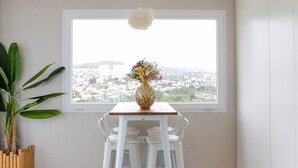 A room with a large window, a white table with a vase, and a potted plant. - Apartment 'Playa Salinas Grupo Terra De Mar' with Sea View, Wi-Fi and Air Conditioning (Calpe)