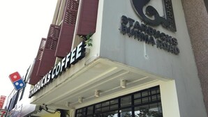 A building with a Starbucks Coffee sign and a large sign with Burmese script. - Minima 8  (George Town)