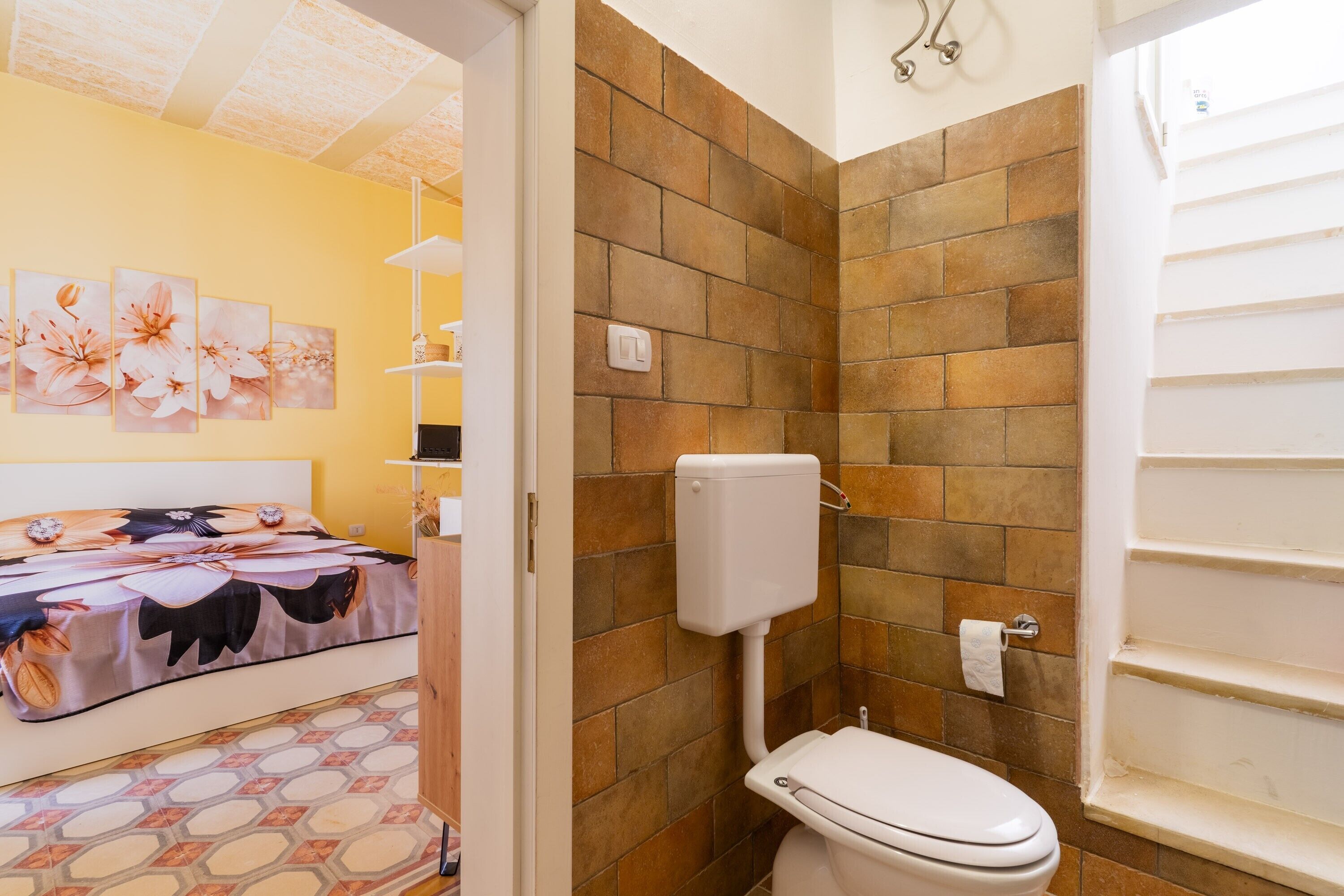 A bathroom with a toilet, a shower, and a sink.