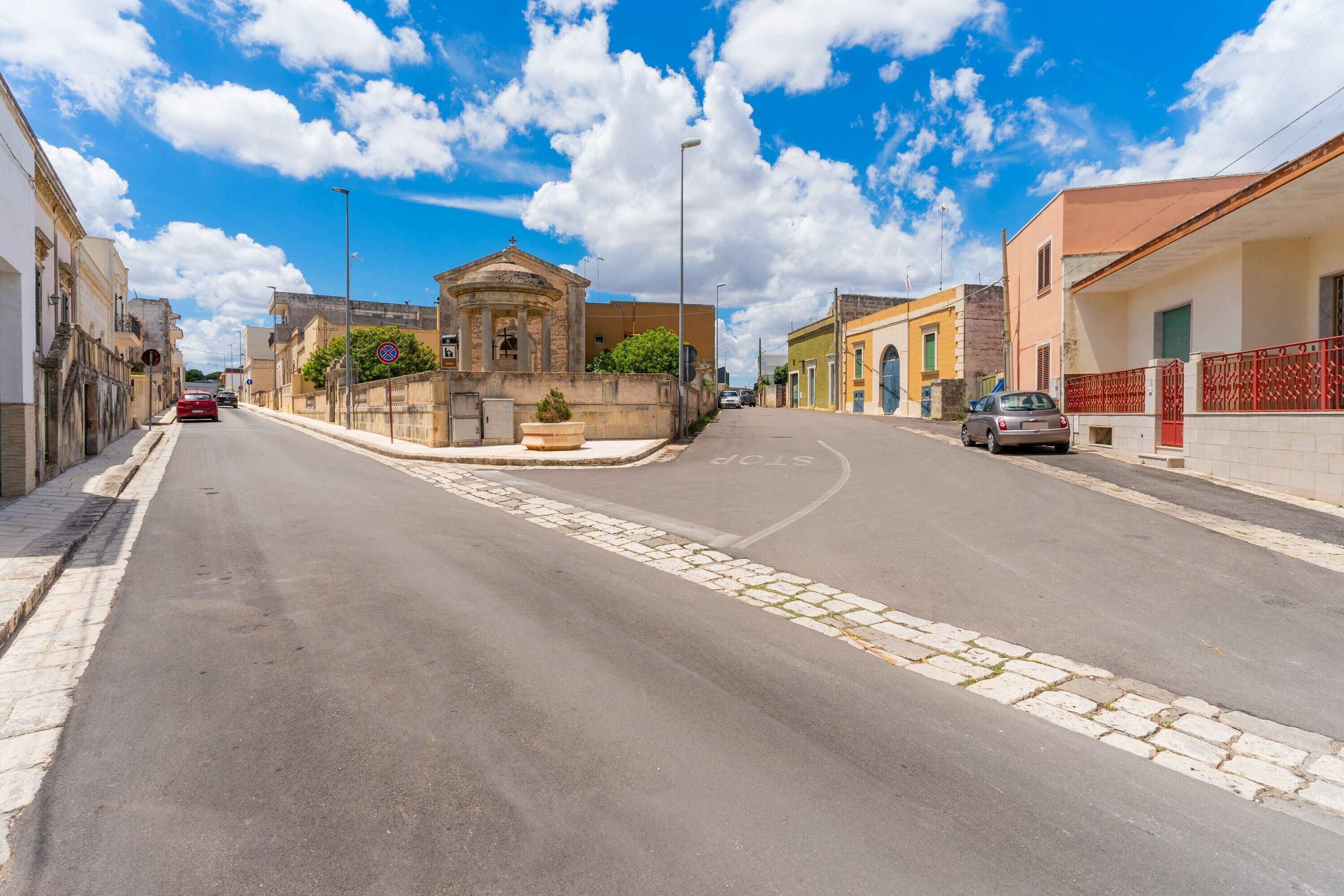 A street with buildings, a clear sky, and a road.