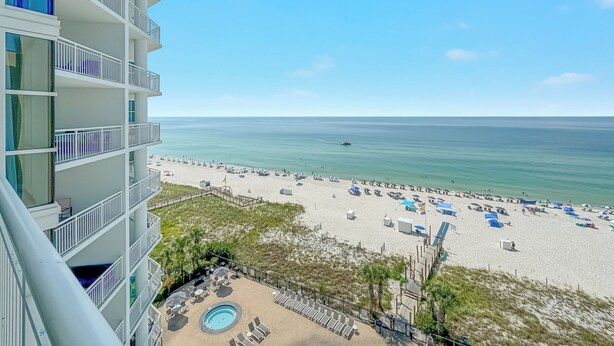 A high-rise hotel with a pool area, beach view, and multiple balconies. - Palacio 704 | Beachfront, Resort Amenities | My Beach Getaways (Pensacola)
