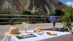 A table set outdoors with a mountain in the background.