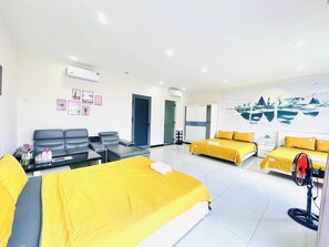 A hotel room with two beds, a sofa, a desk, and a large mural on the wall. - Haleeda Homestay Grand World Phu Quoc (Phu Quoc)