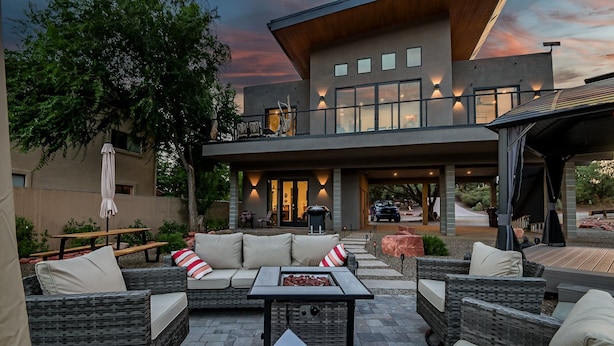 An outdoor patio with wicker furniture, a grill, and a view of the house. - Beautiful Views Of Cathedral Rock, Hot Tub, Fire Pit, Wildlife Sightings, And Stargazing (Sedona)