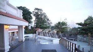An outdoor terrace with a pool, seating areas, and a view of the surrounding greenery. - Hotel FORT28 (Nagpur)