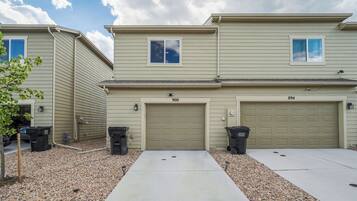 A two-story residential building with numbered garage doors 900 and 894.