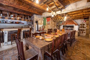 A rustic dining area with a long wooden table set for a meal, surrounded by wooden chairs. - Pool & Wellness Villa Betelgeuse Supernova, Novi Vinodolski, Croatia (Novi Vinodolski)