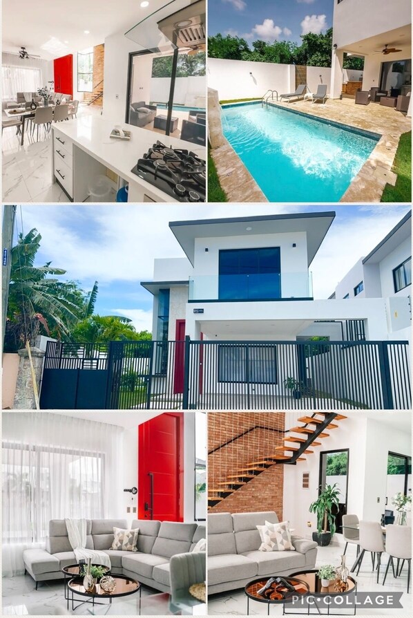 Ein modernes Haus mit Pool, Essbereich und Treppe.