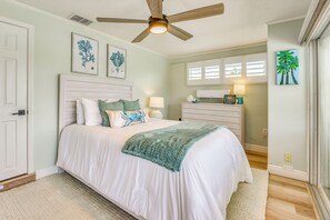 A bedroom with a bed, a ceiling fan, a dresser, and artwork on the walls. - Private Fishing Dock: Waterfront Palmetto Home! (Palmetto)