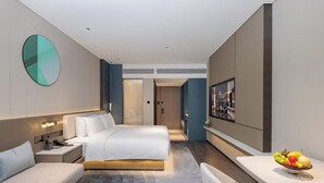 A modern hotel room with a bed, bedside table, and a fruit bowl on a small table. - Grand Madison LongHua Yujing Shenzhen (Shenzhen)