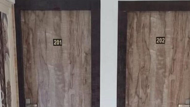 Two wooden doors labeled 201 and 202 in a hallway with a marble floor. - Regencyy Guest House (Kolkata)