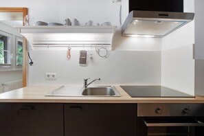 Fridge, stovetop, dishwasher, coffee/tea maker